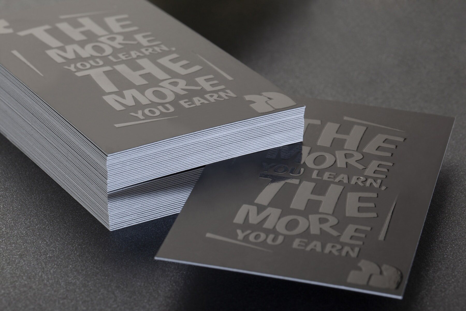 Black business card with raised glossy Spot UV details