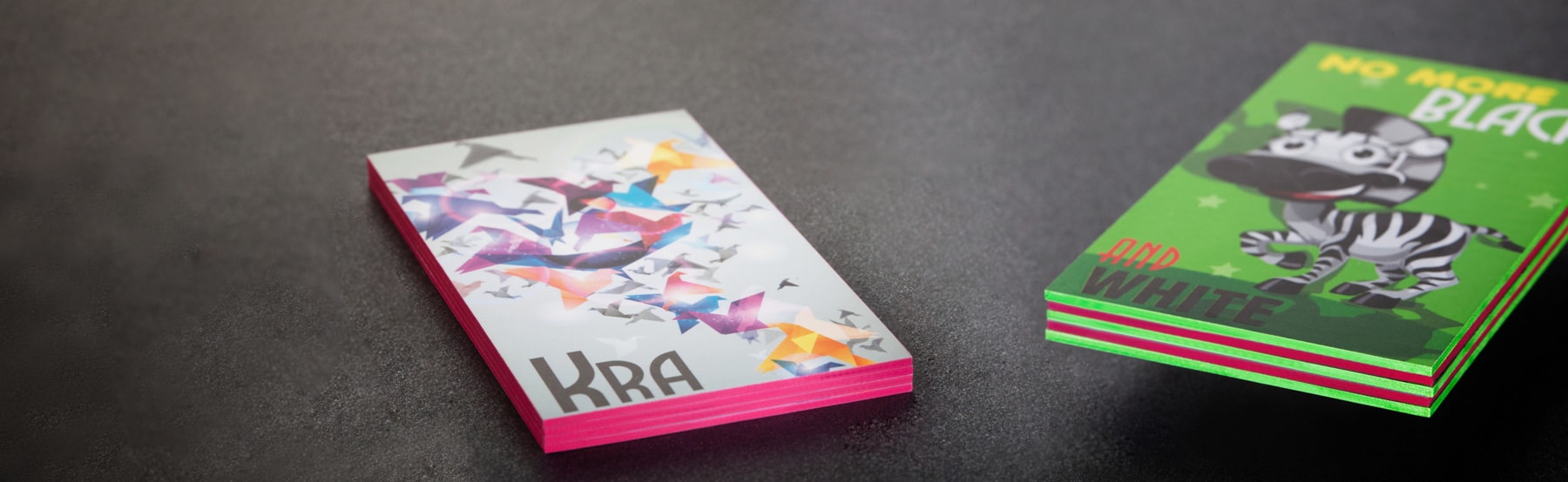 Stacks of thick cards aligned for coloured-edge finishing