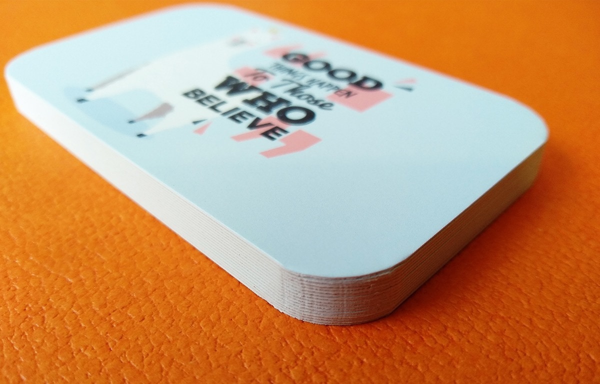 Rounded business cards with artwork positioned inside the curved edge