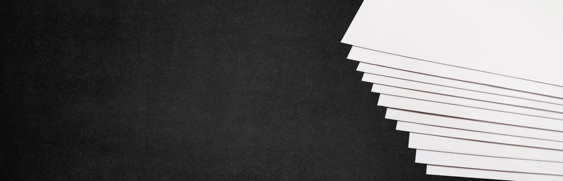 White smooth coated paper sheets viewed from the edge