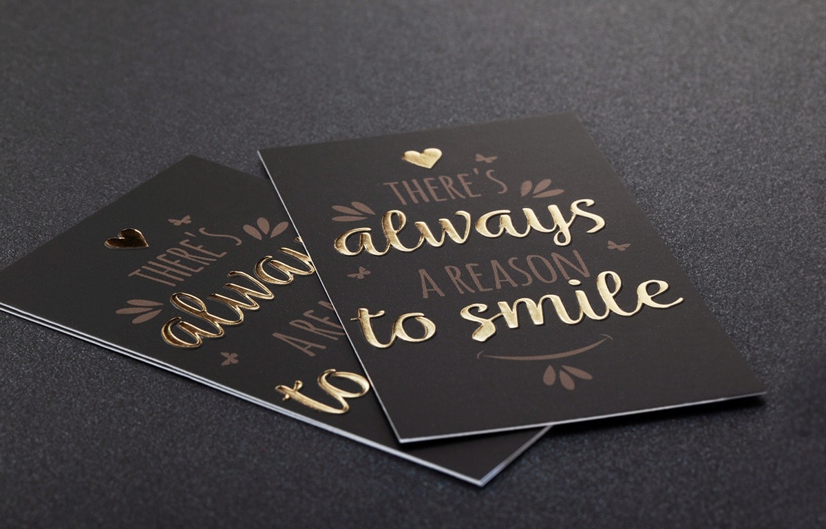 Gold hot foil typography on black business cards