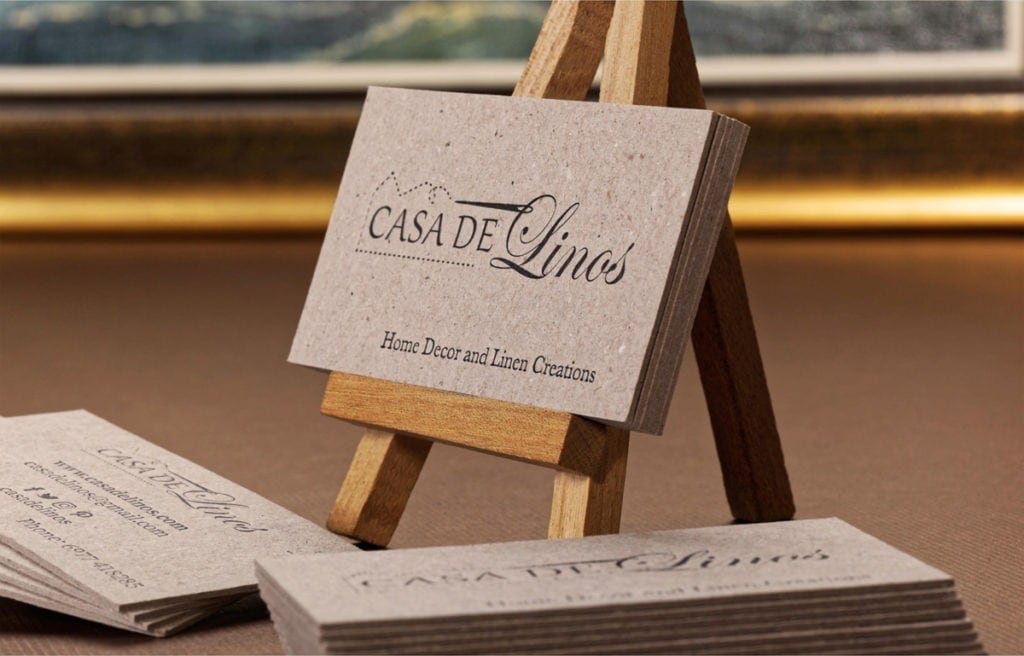 Casa de Linos recycled paperboard cards displayed on a wooden easel