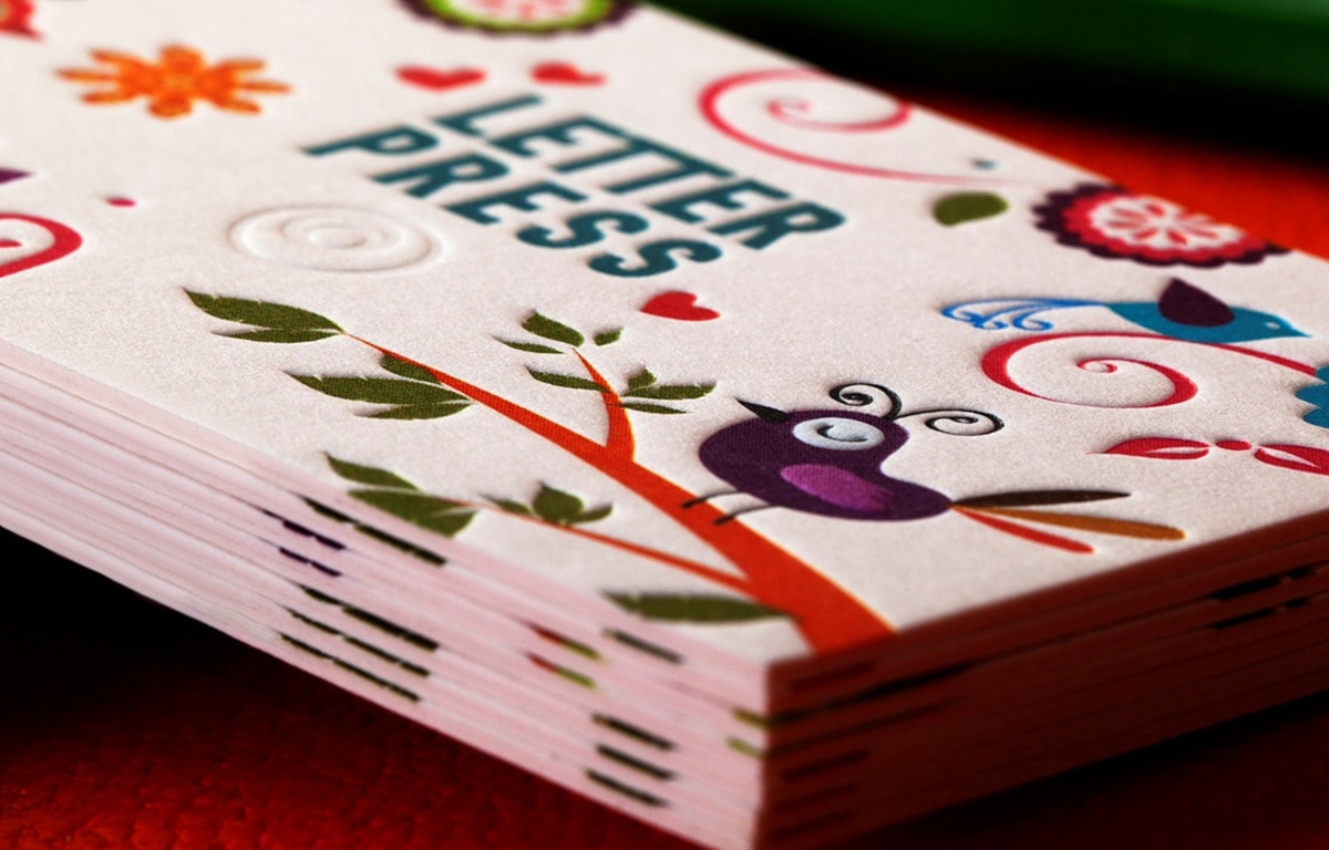 Close view of letterpress lettering in thick white paper