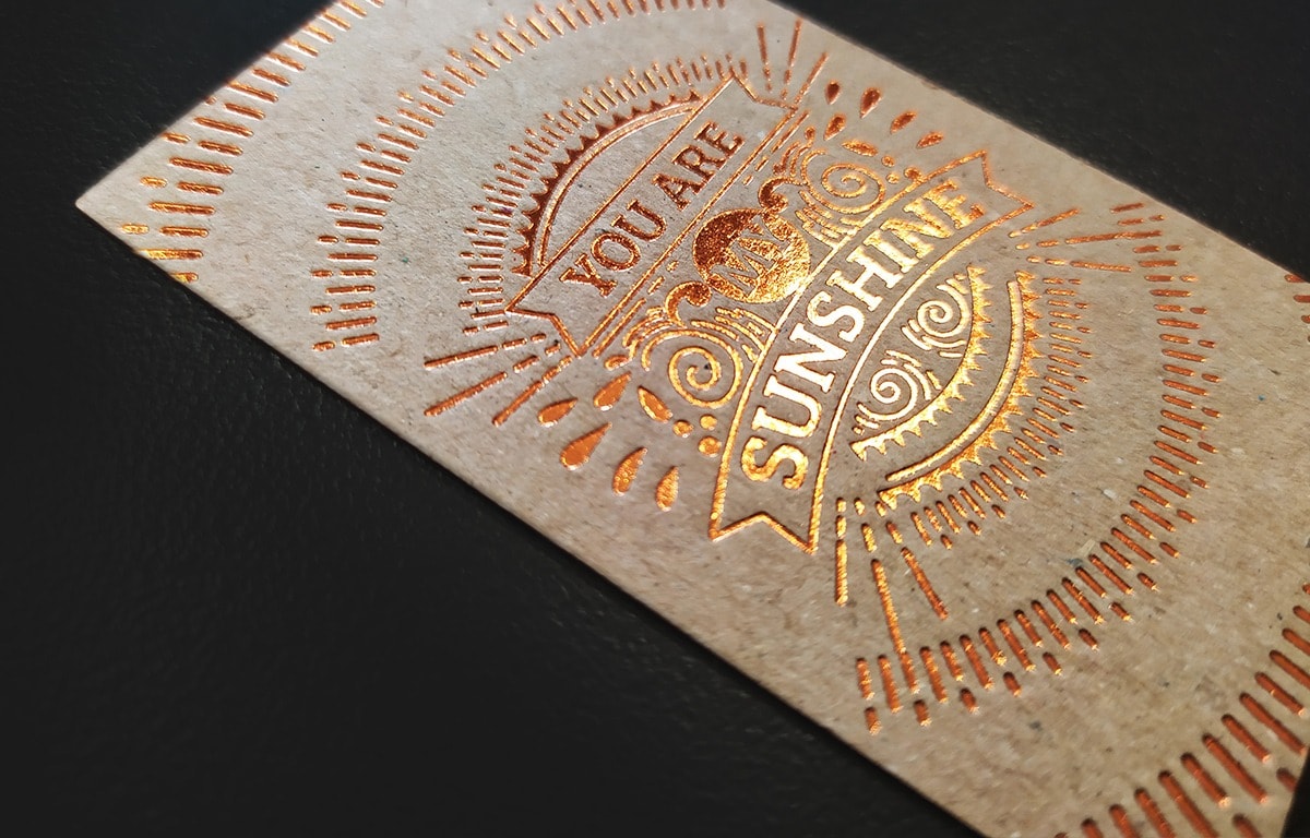 Natural recycled board business card with opaque hot foil detail