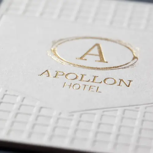 Close detail of gold hot foil and blind geometric impression on the white Sumo house sample