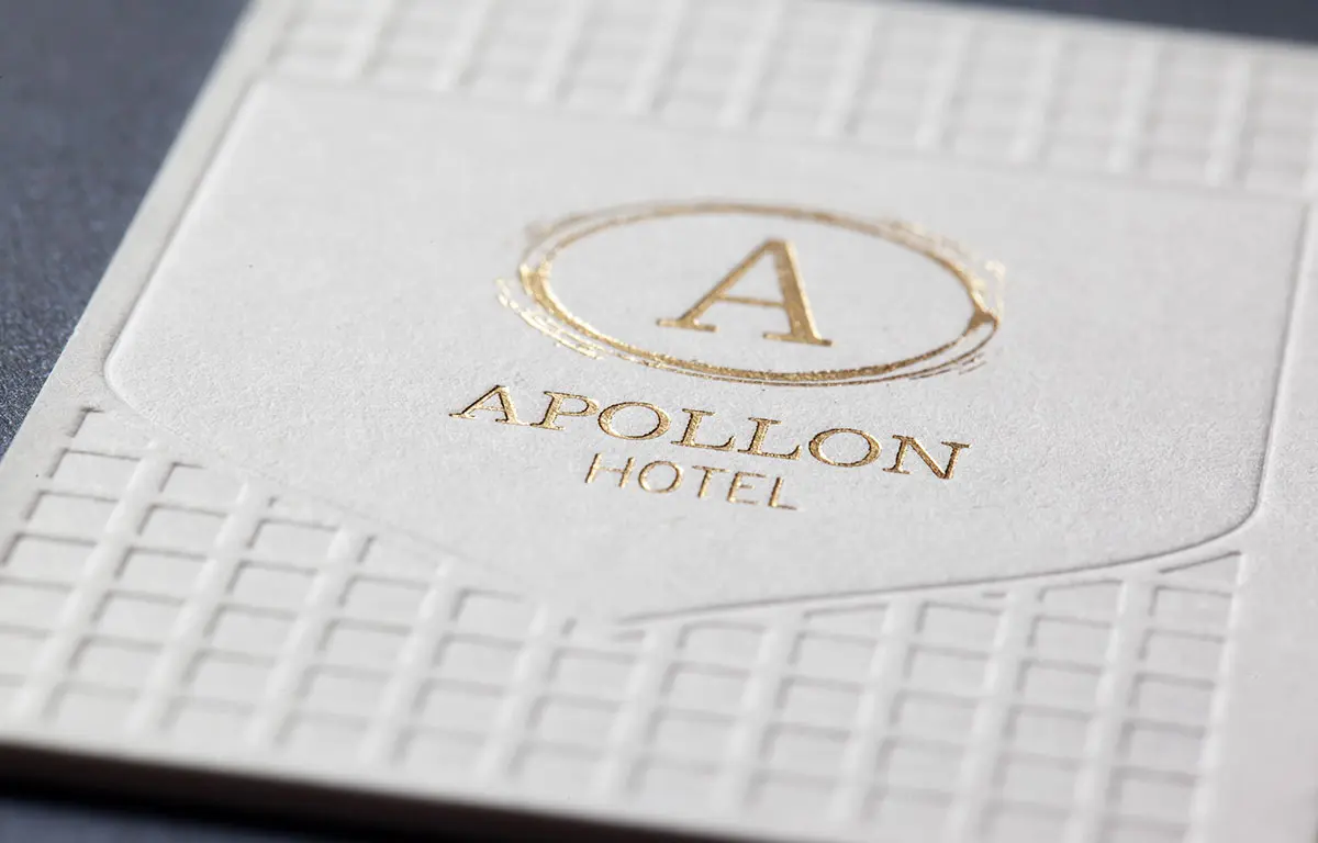 Close detail of gold hot foil and blind geometric impression on the white Sumo house sample