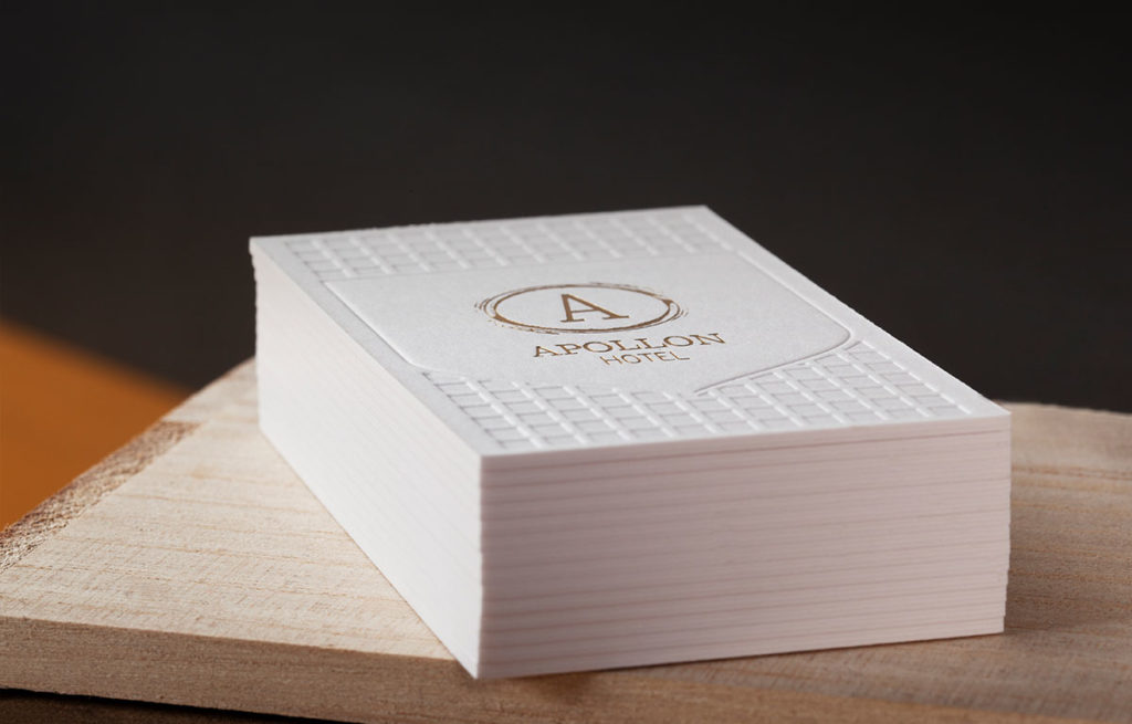 Stack of 1.5 mm white Sumo house-sample cards with gold foil and blind impression