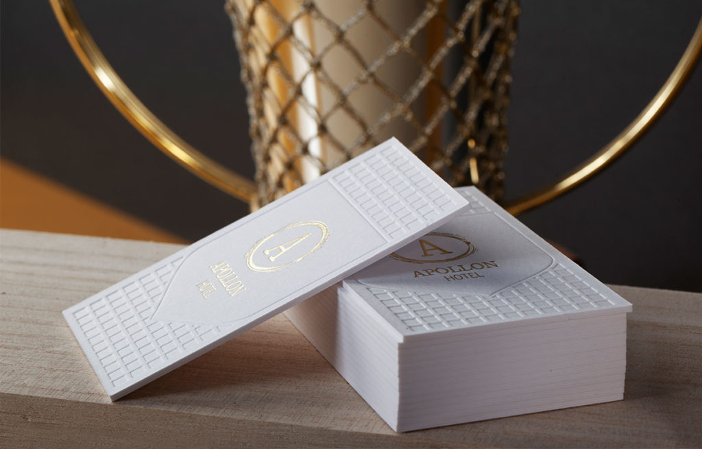 Front and reverse of the white Sumo house sample with reflective gold foil