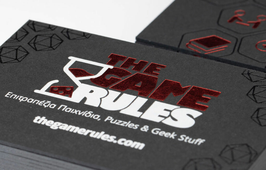 Game Rules card showing white information and red foil symbols on black board