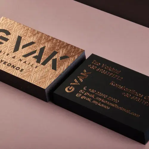 Front and reverse of GVAK business cards with rose-gold foil on black board