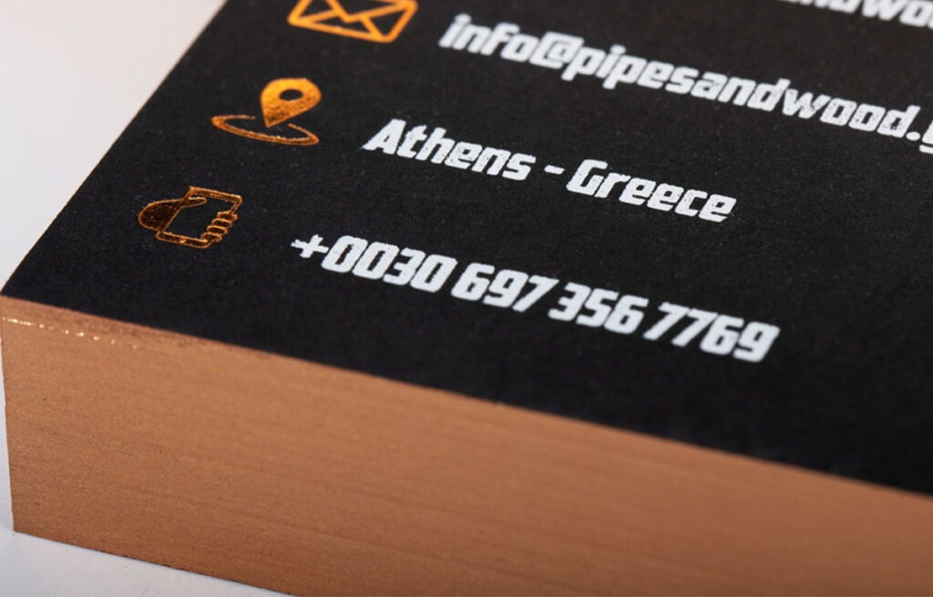 Black business cards with two hot foils and painted edges