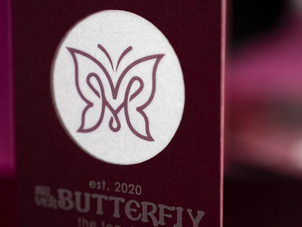 Close detail of the Pantone butterfly visible through the laser-cut circular window