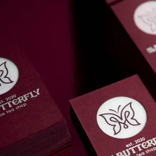 Butterfly house-sample cards in Keaykolour Carmine with matt silver foil and a translucent laser-cut centre