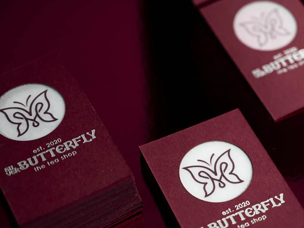 Butterfly house-sample cards in Keaykolour Carmine with matt silver foil and a translucent laser-cut centre