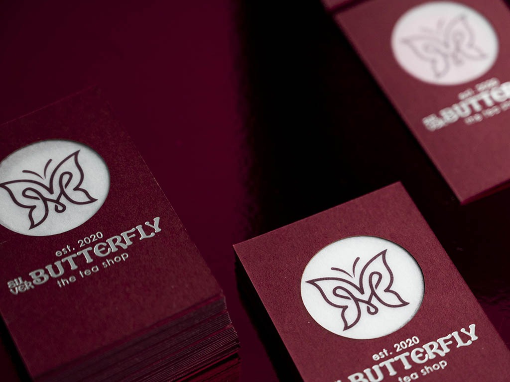 Butterfly house-sample cards in Keaykolour Carmine with matt silver foil and a translucent laser-cut centre