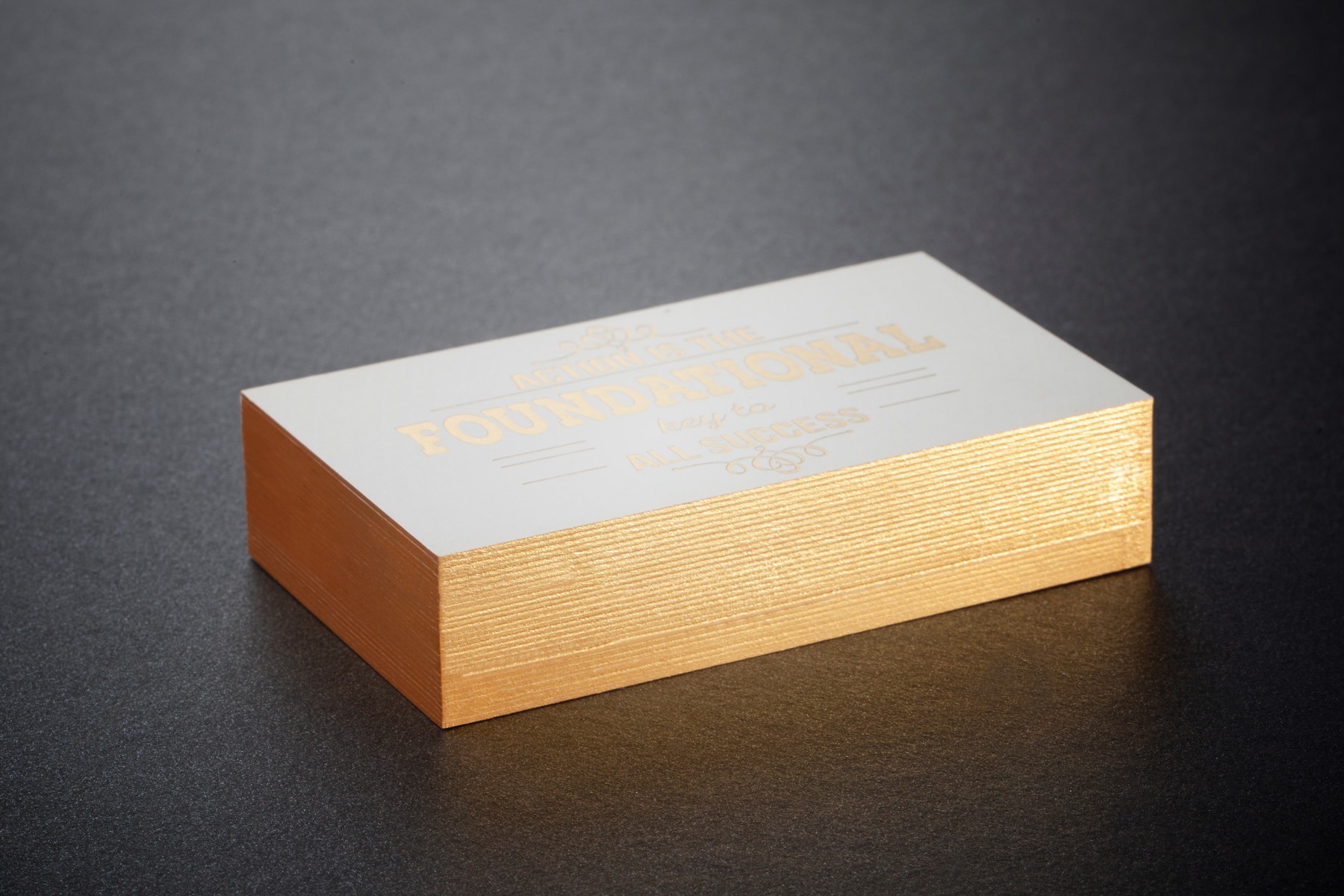 White business cards with gold hot foil and gold painted edges