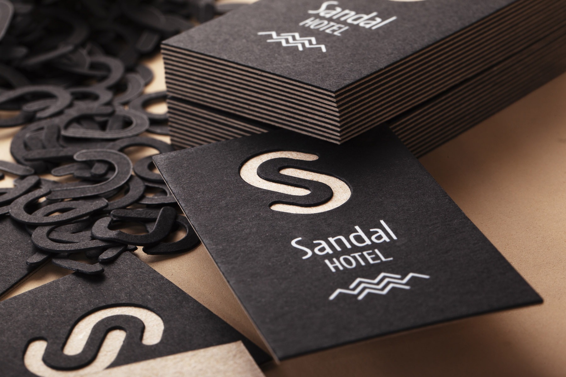Sandal Hotel sample card using Keaykolour Deep Black with white foil and die cutting