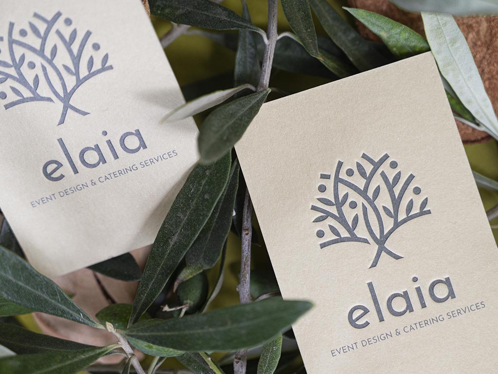 Elaia business card combining blue letterpress with a blind impression