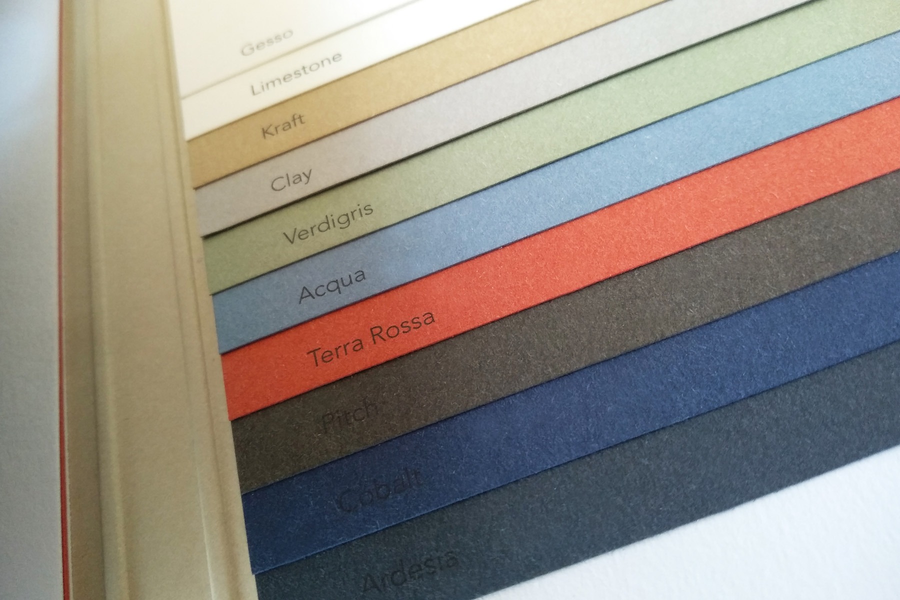 Physical Materica paper swatches showing neutral, mineral, blue, red and dark colours