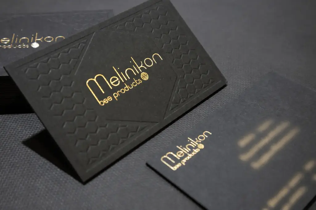 Melinikon card with gold foil and blind impression; personal contact details obscured