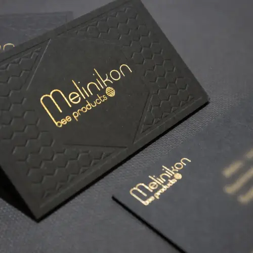 Melinikon card with gold foil and blind impression; personal contact details obscured