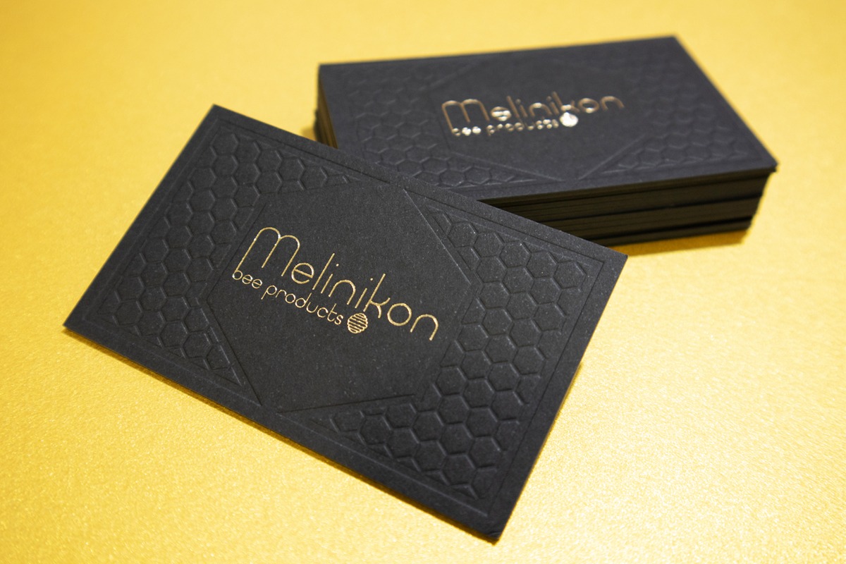 Melinikon black business card with glossy gold foil and honeycomb blind impression