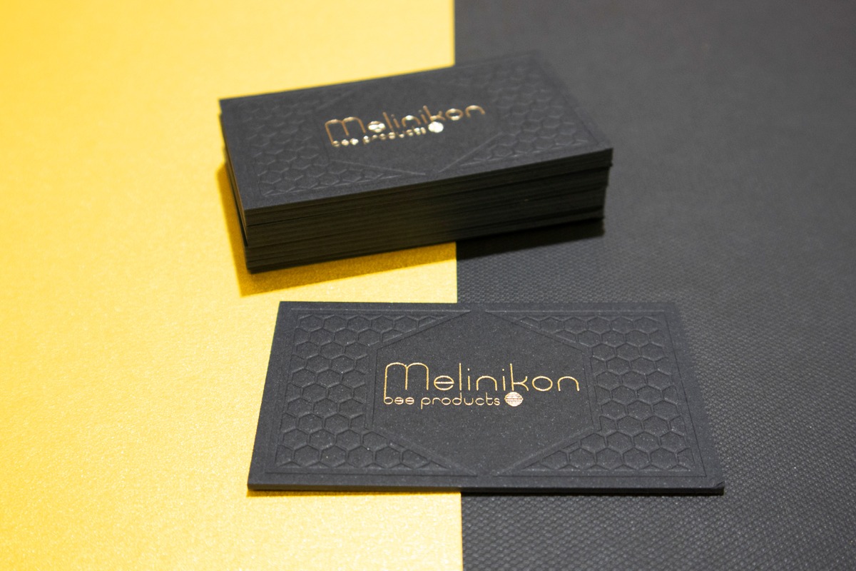 Stack of 1.5 mm black Melinikon business cards with an unpainted black edge