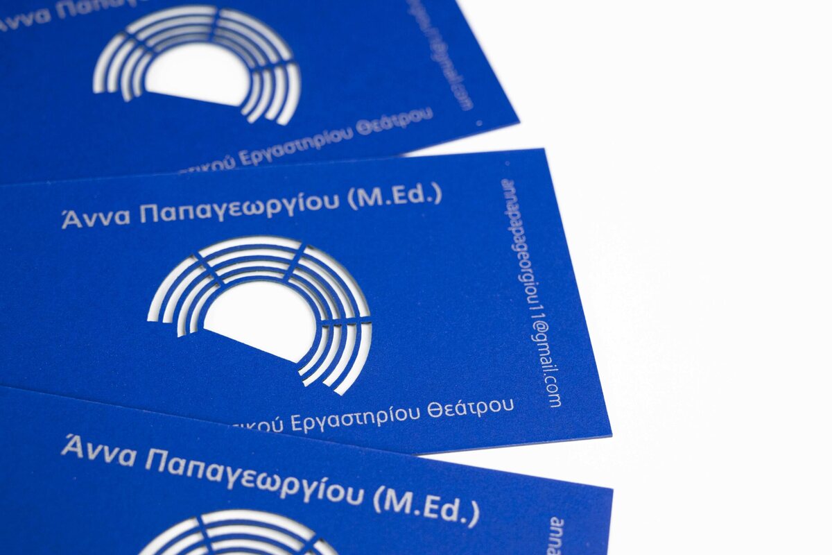Vivid blue business cards with controlled silver Pantone printing and precise laser-cut openings