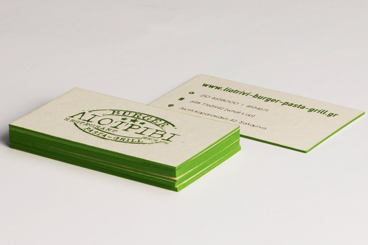 Green printed business cards on textured Woodstock paper with letterpress and painted edges