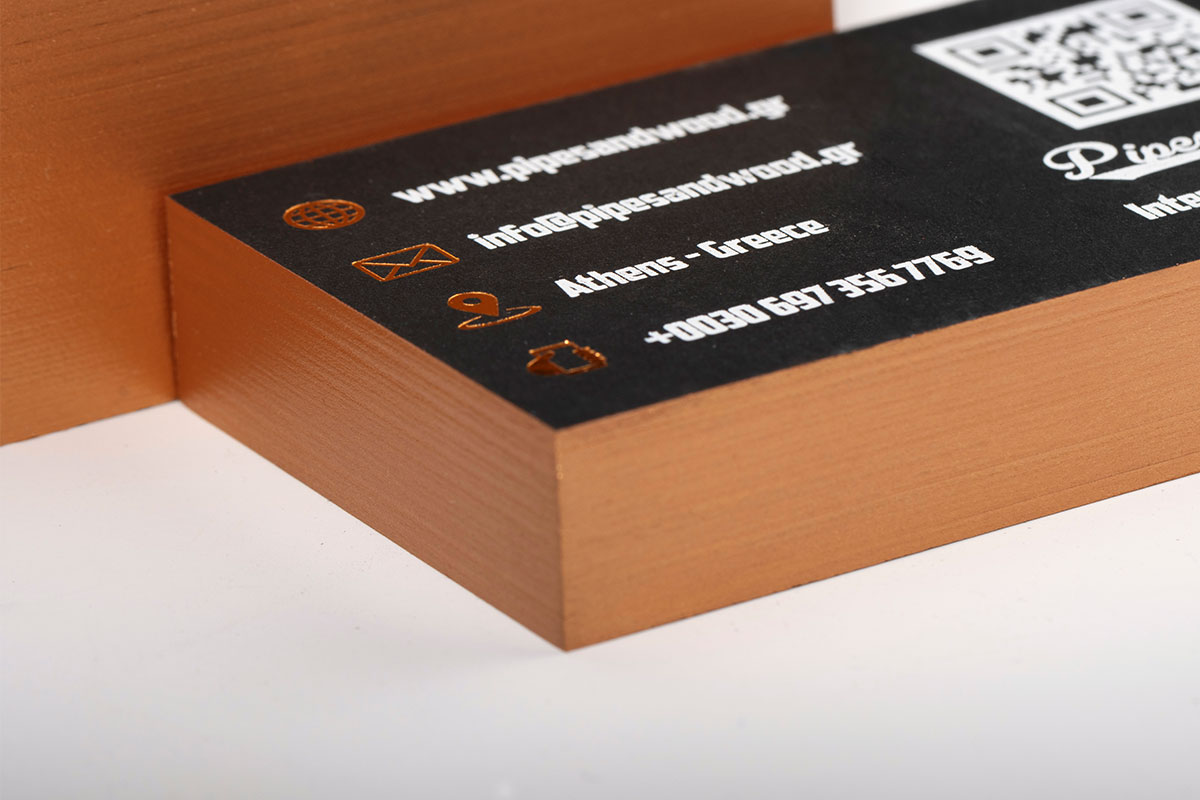 Close view of a thick black card with a bronze painted edge