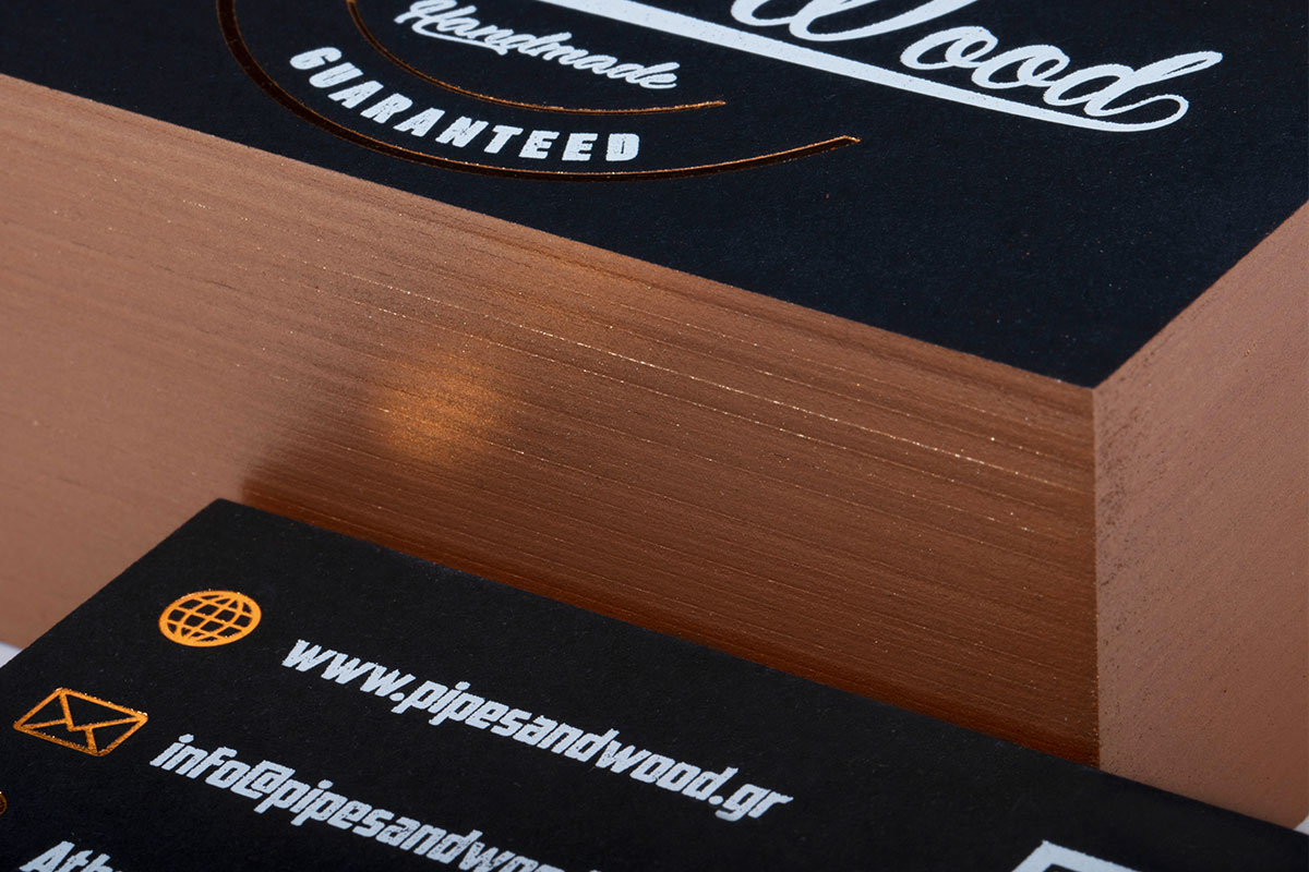 Stack of black business cards with bronze painted edges