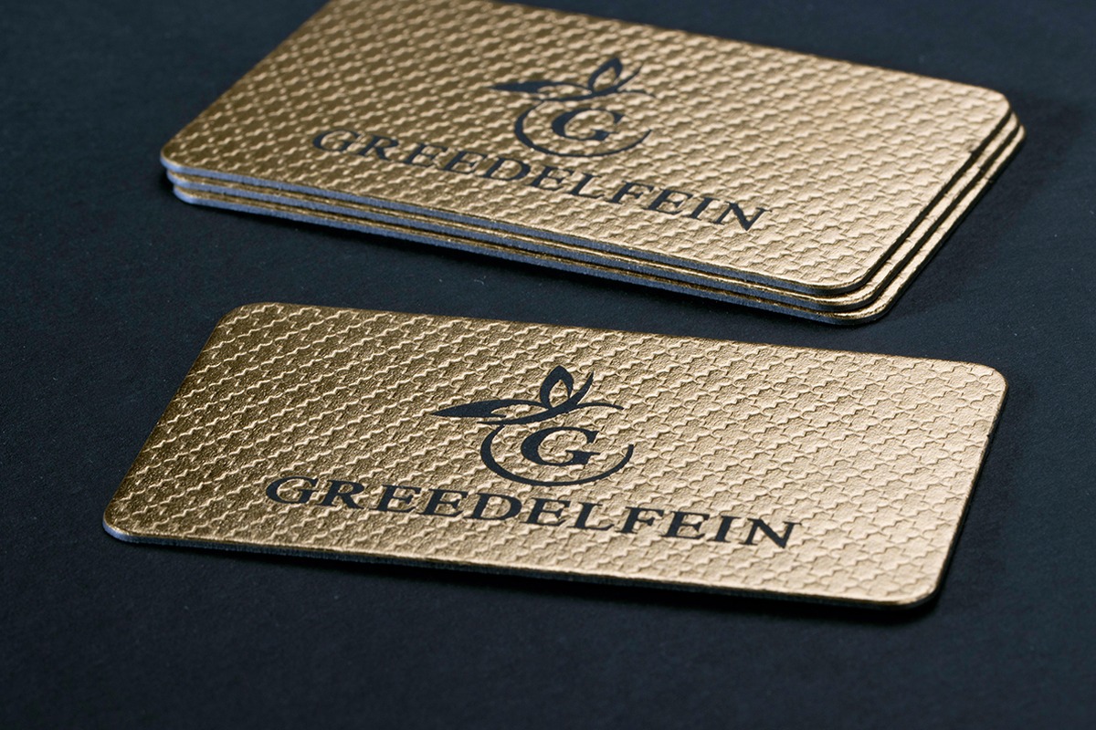 Gold and black business cards with a consistent rounded radius