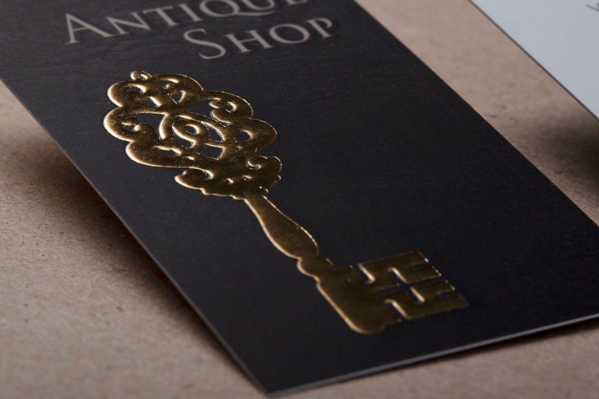 Gold embossed key detail on a black velvet-finish business card